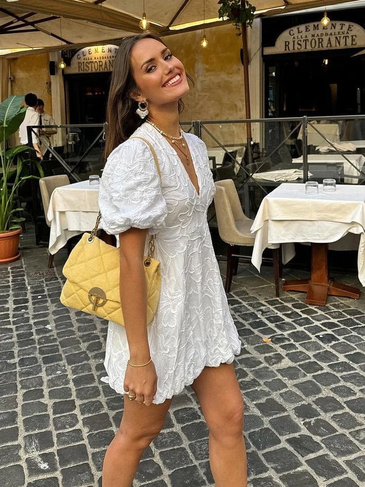 Vestido curto de mulher com mangas bufantes e detalhe texturizado